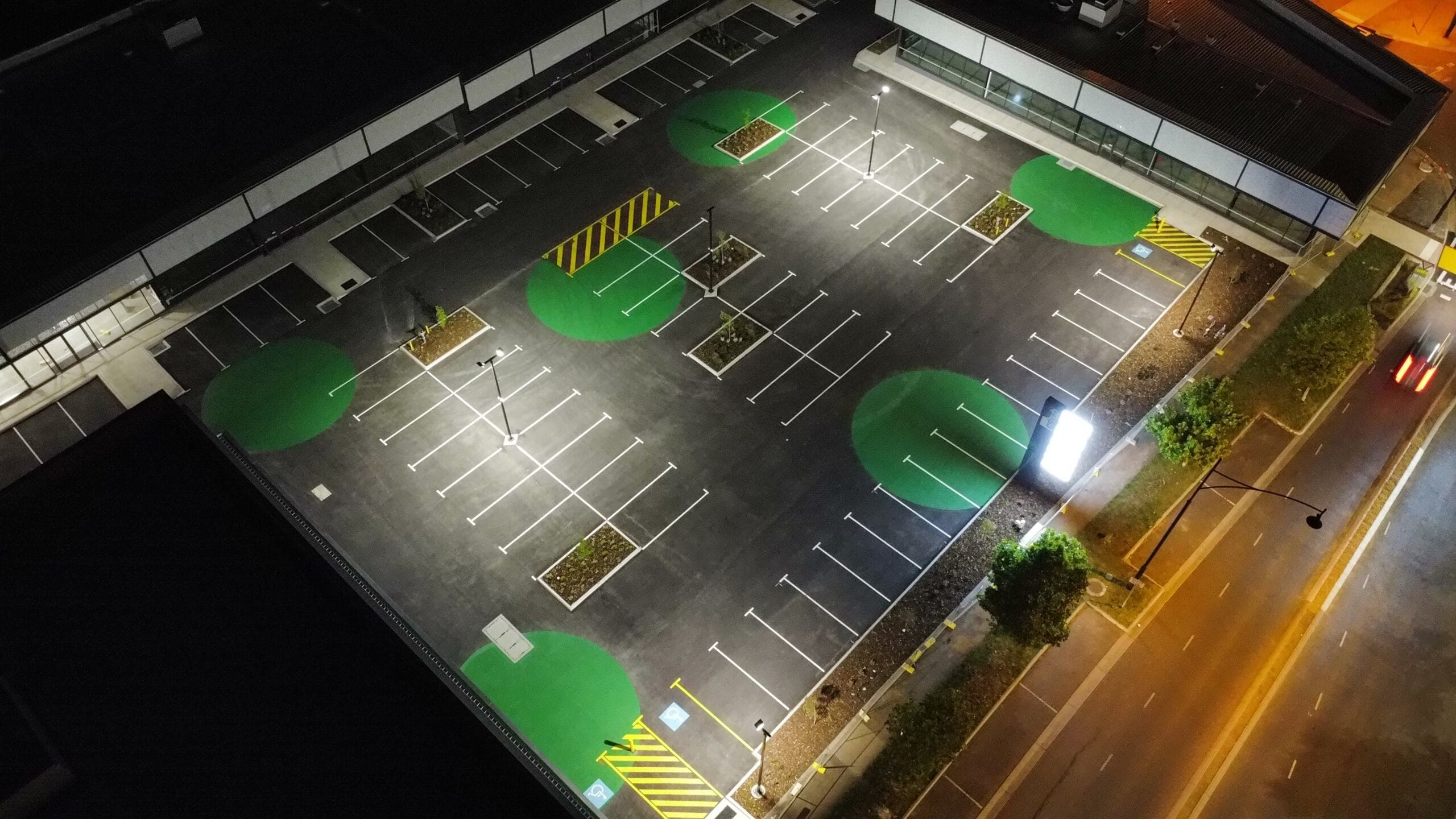 Aerial view of a line-marked commercial car park in Melbourne at night
